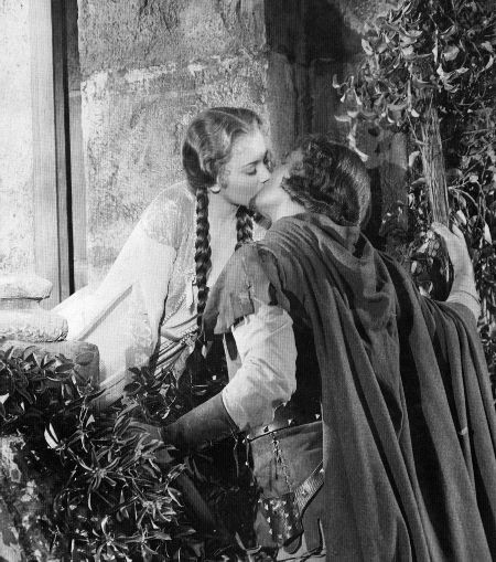 Errol Flyn kissing Olivia de Haviland in the 1938 film Robin Hood